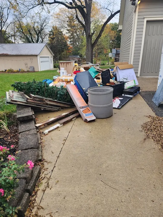 Dumpster being loaded with debris for 10 Yard Dumpster Rental in Picnic Point
